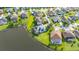 Beautiful lakefront property with screened-in pool, lush landscaping, and solar panels for energy efficiency at 1760 Boat Launch Rd, Kissimmee, FL 34746