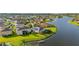 Waterfront homes with lush green lawns lead to a serene lake in a beautiful suburban community at 1760 Boat Launch Rd, Kissimmee, FL 34746