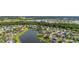 Expansive aerial shot showcases homes nestled around a serene lake, surrounded by trees at 1760 Boat Launch Rd, Kissimmee, FL 34746