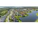 Aerial view of homes on a lake with well-maintained lawns and mature trees at 1760 Boat Launch Rd, Kissimmee, FL 34746
