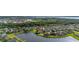 An elevated view highlighting a lakefront neighborhood with manicured lawns, and scenic water views at 1760 Boat Launch Rd, Kissimmee, FL 34746
