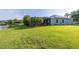 Expansive backyard with manicured lawn, solar panels, and beautiful lake views at 1760 Boat Launch Rd, Kissimmee, FL 34746
