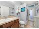 Cozy bathroom features vanity with storage, toilet, and walk-in shower, along with decorative seashell artwork at 1760 Boat Launch Rd, Kissimmee, FL 34746