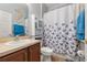 Nicely decorated bathroom with vanity, toilet, bathtub with butterfly-themed shower curtain and vanity at 1760 Boat Launch Rd, Kissimmee, FL 34746