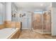Luxurious bathroom featuring a soaking tub, glass-enclosed shower, and stylish tile work at 1760 Boat Launch Rd, Kissimmee, FL 34746