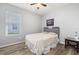 This simple bedroom features hardwood floors, gray walls, and a window with lots of natural light at 1760 Boat Launch Rd, Kissimmee, FL 34746