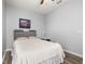 Cozy bedroom features wood floors, ceiling fan, and minimalist decor, perfect for relaxation at 1760 Boat Launch Rd, Kissimmee, FL 34746