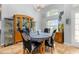 Dining area with natural light, a chandelier, a display cabinet, and seating for four at 1760 Boat Launch Rd, Kissimmee, FL 34746