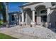 Home's front porch with stone landscaping, decorative pillars, and a cozy seating area at 1760 Boat Launch Rd, Kissimmee, FL 34746