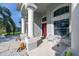 Covered porch featuring columns and a seating area with a view of the front yard at 1760 Boat Launch Rd, Kissimmee, FL 34746