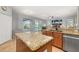 Island kitchen with stainless steel appliances, granite countertops, and view into the living space at 1760 Boat Launch Rd, Kissimmee, FL 34746