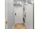 Convenient laundry room features a stacked washer and dryer and built in shelf storage at 1760 Boat Launch Rd, Kissimmee, FL 34746