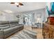 Living room with sliding glass doors and a comfortable leather sofa overlooking the lanai and yard at 1760 Boat Launch Rd, Kissimmee, FL 34746