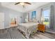 Comfortable main bedroom with wood floors, a tray ceiling and ensuite bathroom at 1760 Boat Launch Rd, Kissimmee, FL 34746