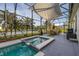 Outdoor dining area features a screened enclosure and a picturesque lake backdrop at 1760 Boat Launch Rd, Kissimmee, FL 34746