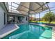 Sparkling swimming pool inside a screened enclosure overlooking the waterfront at 1760 Boat Launch Rd, Kissimmee, FL 34746
