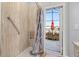 Accessible shower with grab bar opens to screened-in patio with lake view and outdoor seating area at 1760 Boat Launch Rd, Kissimmee, FL 34746