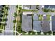Aerial view showcasing the home's roof, driveway, landscaping and nearby street and sidewalks at 1801 Coastal Ct, Celebration, FL 34747
