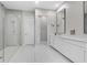 Modern bathroom with glass walk-in shower, white cabinets, and stylish mirror at 1801 Coastal Ct, Celebration, FL 34747