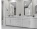 Modern bathroom featuring double vanity with white cabinetry and contemporary black framed mirrors at 1801 Coastal Ct, Celebration, FL 34747