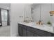 Bathroom featuring a dual sink vanity with gray cabinets and gold hardware and accents at 1801 Coastal Ct, Celebration, FL 34747