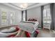 Bright bedroom with tray ceilings, hardwood floors, plantation shutters, and stylish decor at 1801 Coastal Ct, Celebration, FL 34747