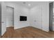 Neutral bedroom with hardwood floors, TV, double doors, and a modern aesthetic at 1801 Coastal Ct, Celebration, FL 34747