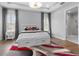 Bedroom with white walls, hardwood floors, tray ceilings, and bedside tables at 1801 Coastal Ct, Celebration, FL 34747