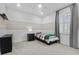 Modern bedroom with carpet, and light bright colors, a decorative wall, and a large window at 1801 Coastal Ct, Celebration, FL 34747