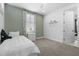 Bedroom with a single bed, a large window, carpet, and a view into an adjoining room at 1801 Coastal Ct, Celebration, FL 34747