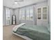 Serene bedroom featuring plantation shutters and neutral walls with a ceiling fan and queen sized bed at 1801 Coastal Ct, Celebration, FL 34747