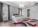 Bedroom with tray ceilings, recessed lights, hardwood floors, and access to bathroom at 1801 Coastal Ct, Celebration, FL 34747