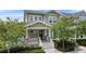 Charming two-story home with a welcoming front porch and lush landscaping at 1801 Coastal Ct, Celebration, FL 34747