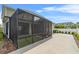 Rear exterior view of house shows the covered patio, fenced yard, and driveway at 1801 Coastal Ct, Celebration, FL 34747
