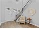 Bright foyer with hardwood floors, staircase, and stylish decor at 1801 Coastal Ct, Celebration, FL 34747