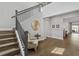 Grand foyer with hardwood floors, staircase, and stylish decor at 1801 Coastal Ct, Celebration, FL 34747