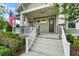 Inviting covered porch with stone accents and a welcoming entrance at 1801 Coastal Ct, Celebration, FL 34747