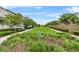 Well maintained green space with manicured shrubs and trees between houses at 1801 Coastal Ct, Celebration, FL 34747