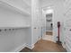 Hallway with white shelving, storage closet, hardwood floors, and neutral paint at 1801 Coastal Ct, Celebration, FL 34747