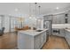 Open kitchen with a large island, stainless steel appliances, and an adjacent dining area at 1801 Coastal Ct, Celebration, FL 34747