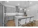 A modern kitchen boasts gray cabinetry, a spacious island, stainless steel appliances, and hardwood floors at 1801 Coastal Ct, Celebration, FL 34747