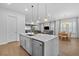 Open kitchen with a large island, stainless steel appliances, and a view of the living and dining areas at 1801 Coastal Ct, Celebration, FL 34747