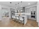 Stylish kitchen with gray cabinets, a central island with barstools, and hardwood flooring at 1801 Coastal Ct, Celebration, FL 34747