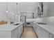 Modern kitchen with gray cabinets, a spacious island, stainless steel appliances, and hardwood flooring at 1801 Coastal Ct, Celebration, FL 34747