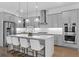 Modern kitchen featuring gray cabinets, a large island with seating, and stainless steel appliances at 1801 Coastal Ct, Celebration, FL 34747