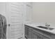 Laundry room features gray cabinets, sink, white countertops, and modern fixtures at 1801 Coastal Ct, Celebration, FL 34747