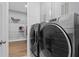 Laundry room with new washer and dryer, wire rack shelving, and tile floors at 1801 Coastal Ct, Celebration, FL 34747