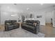 Open concept living space with two leather sofas and hardwood floors at 1801 Coastal Ct, Celebration, FL 34747