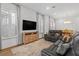 Open living space with large windows, wood floors and a leather sofa at 1801 Coastal Ct, Celebration, FL 34747
