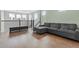Cozy loft area with a gray sectional sofa, ottoman, and an abundance of natural light at 1801 Coastal Ct, Celebration, FL 34747